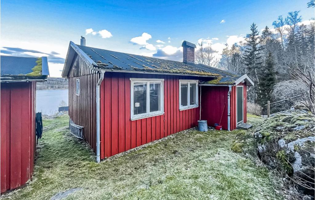 a red house with a window on the side of it at Nice Home In Bredared With Wifi 