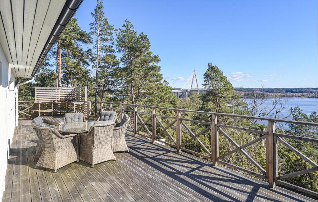 a deck with chairs and a table and a view of the water at 2 Bedroom Lovely Home In Uddevalla in Uddevalla