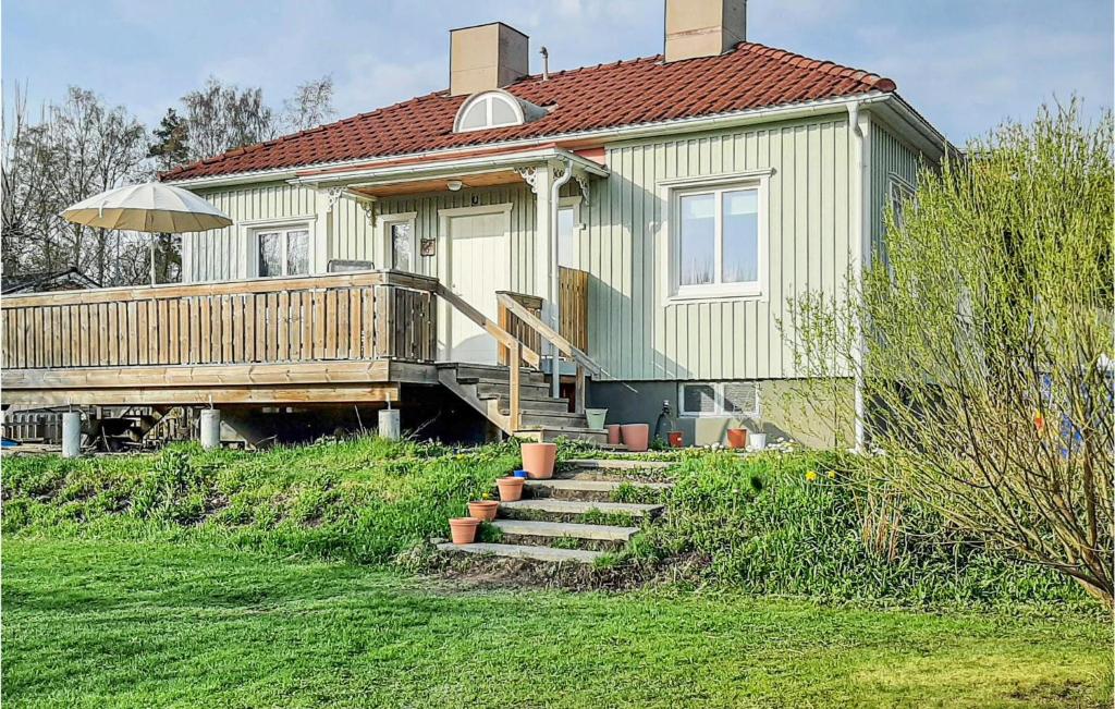 a house with a porch and stairs leading to it at 3 Bedroom Awesome Home In Arvika in Arvika
