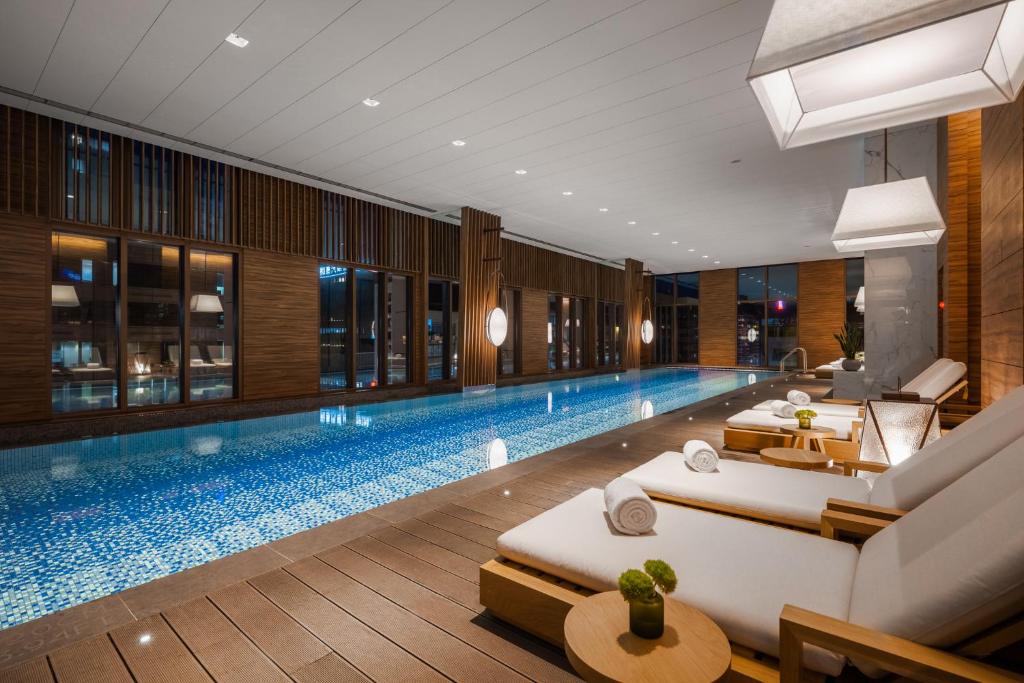 a swimming pool with two beds in a hotel at Humble Boutique Hotel in Taipei