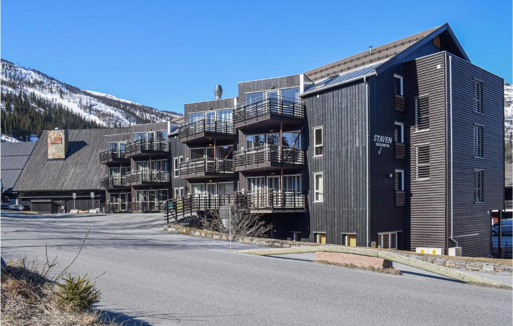 a large building with balconies on the side of a road at Staven Appartments in Hemsedal