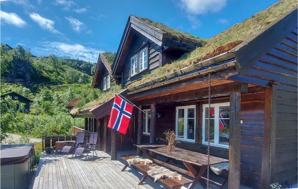 a house with a grass roof with a wooden deck at Lovely Home In seral With Kitchen in Åseral