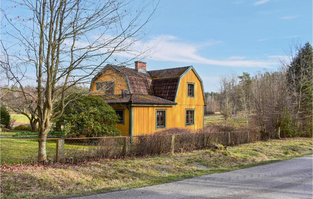 a yellow house sitting on the side of a road at Pet Friendly Home In Mrrum With Kitchen in Mörrum