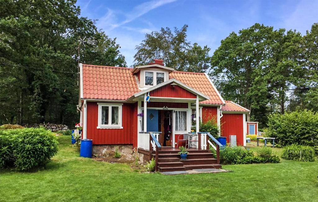 a red tiny house with a red roof at Awesome Home In Sturk With Kitchen in Sturkö