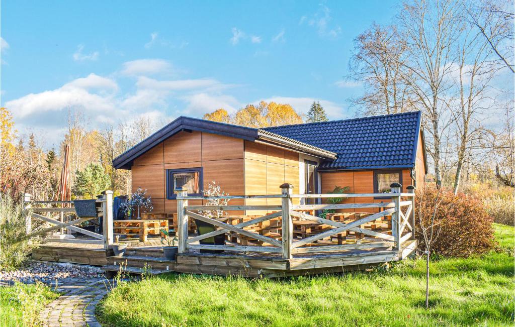 a log cabin with a wooden fence in front of it at Stunning Home In Huskvarna With House A Panoramic View in Huskvarna