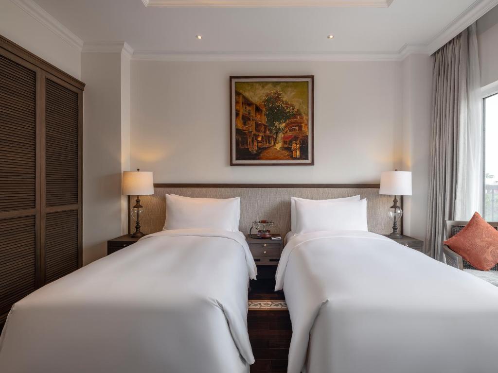 Postel nebo postele na pokoji v ubytování De Syloia Hotel