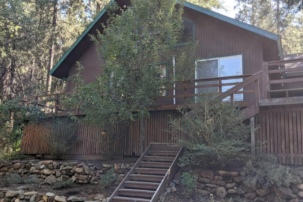 a house with a staircase leading up to it at Pierce's Cabin in Miramonte