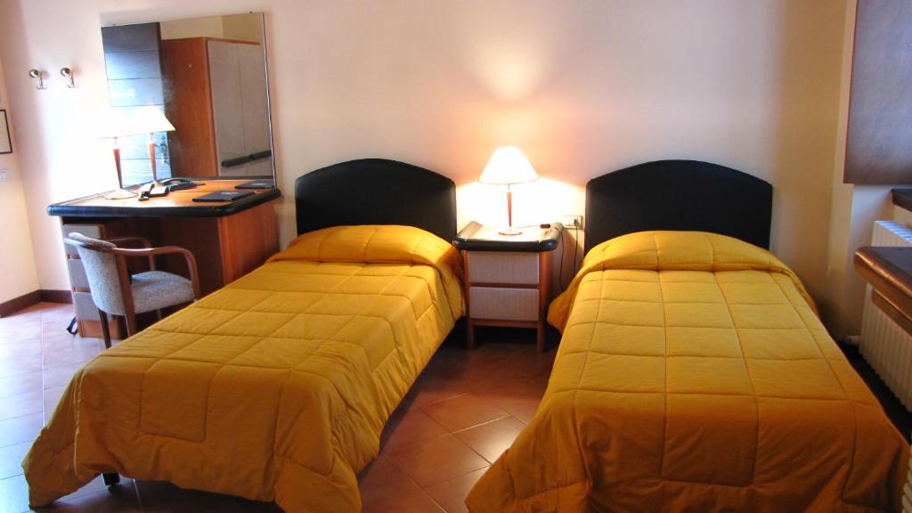 Łóżko lub łóżka w pokoju w obiekcie Agriturismo Cassinazza