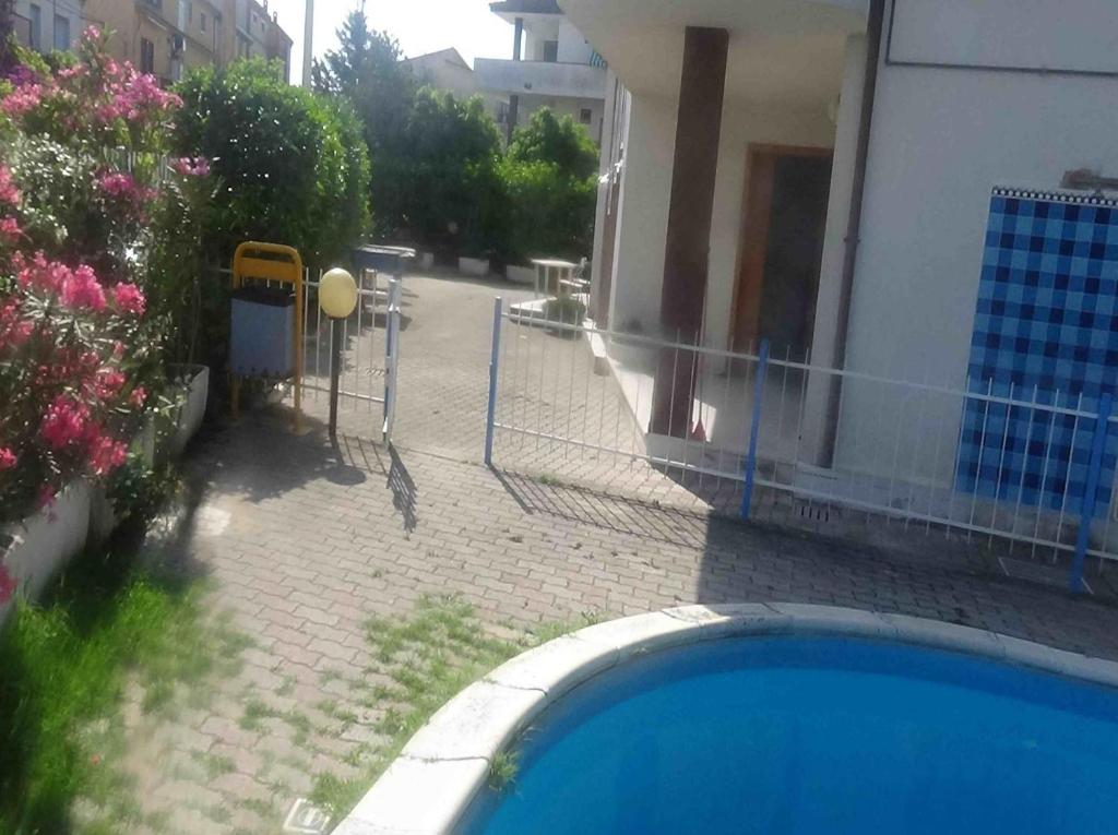 a fence next to a house with a swimming pool at Villa Felicia in Villapiana