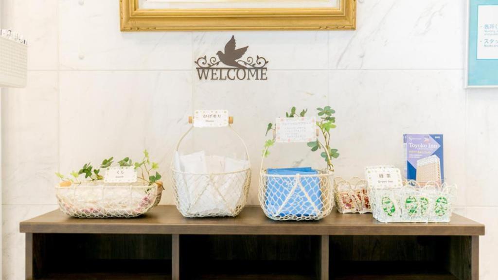 a shelf with four potted plants on it at Toyoko Inn Chubu International Airport No1 in Tokoname