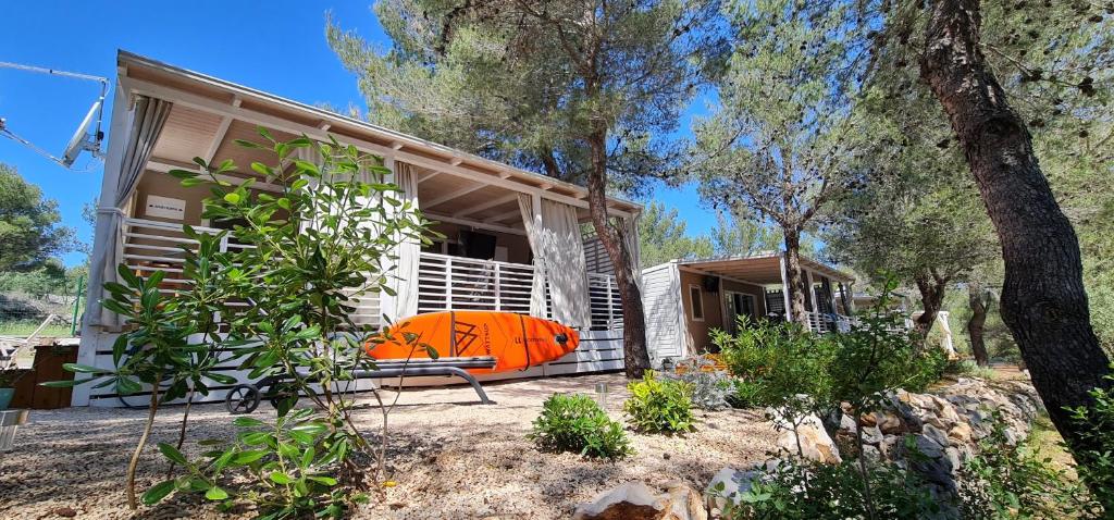 a house with a bench in front of it at Mobile home Andreana in Jezera