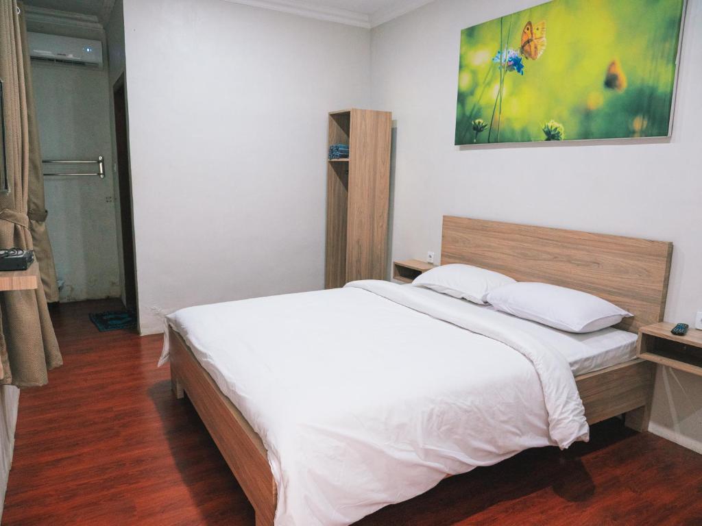 Postel nebo postele na pokoji v ubytování Tumpaksewu Homestay