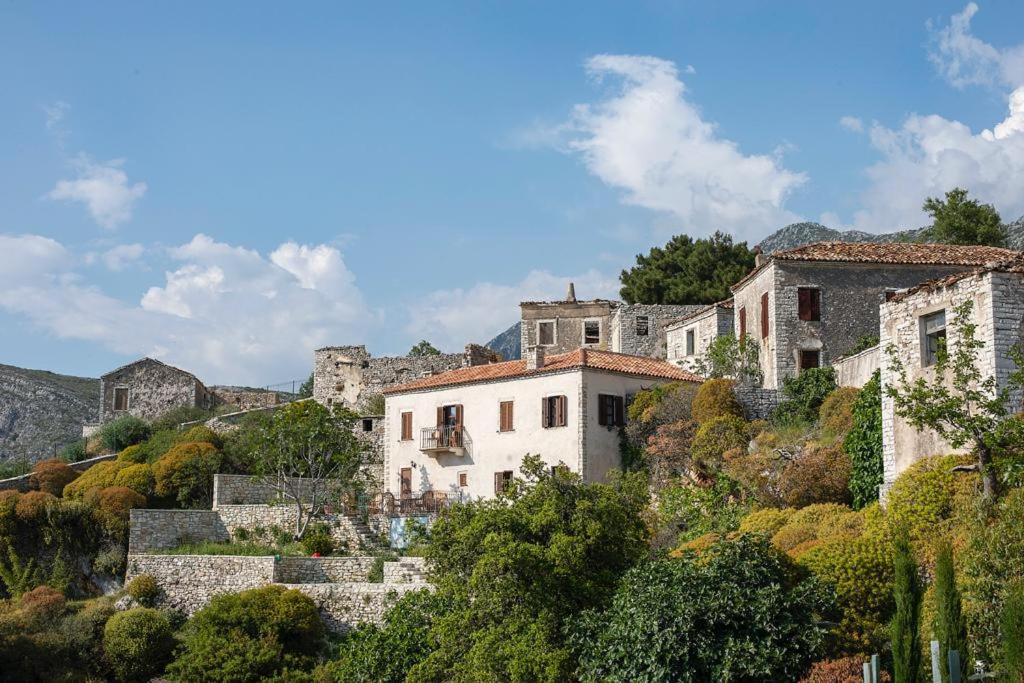 a group of buildings on a hill with trees at Villa Belvedere, Upper Qeparo in Himare