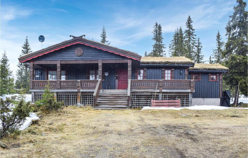 a log home with a red and black house at Stunning Home In Sjusjen With House A Mountain View in Sjusjøen