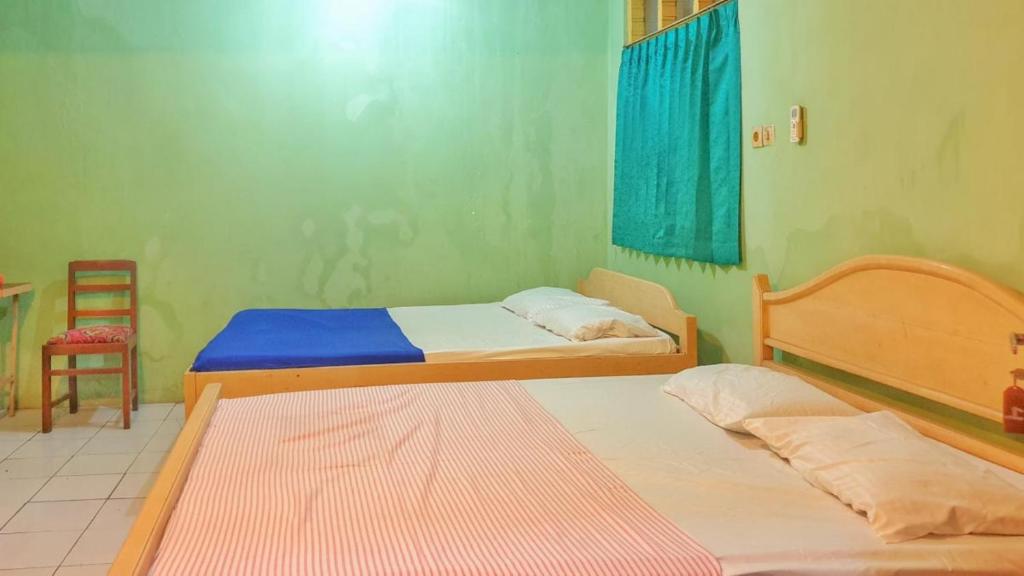 Postel nebo postele na pokoji v ubytování Hotel Jaya Kusuma near Candi Prambanan Mitra RedDoorz
