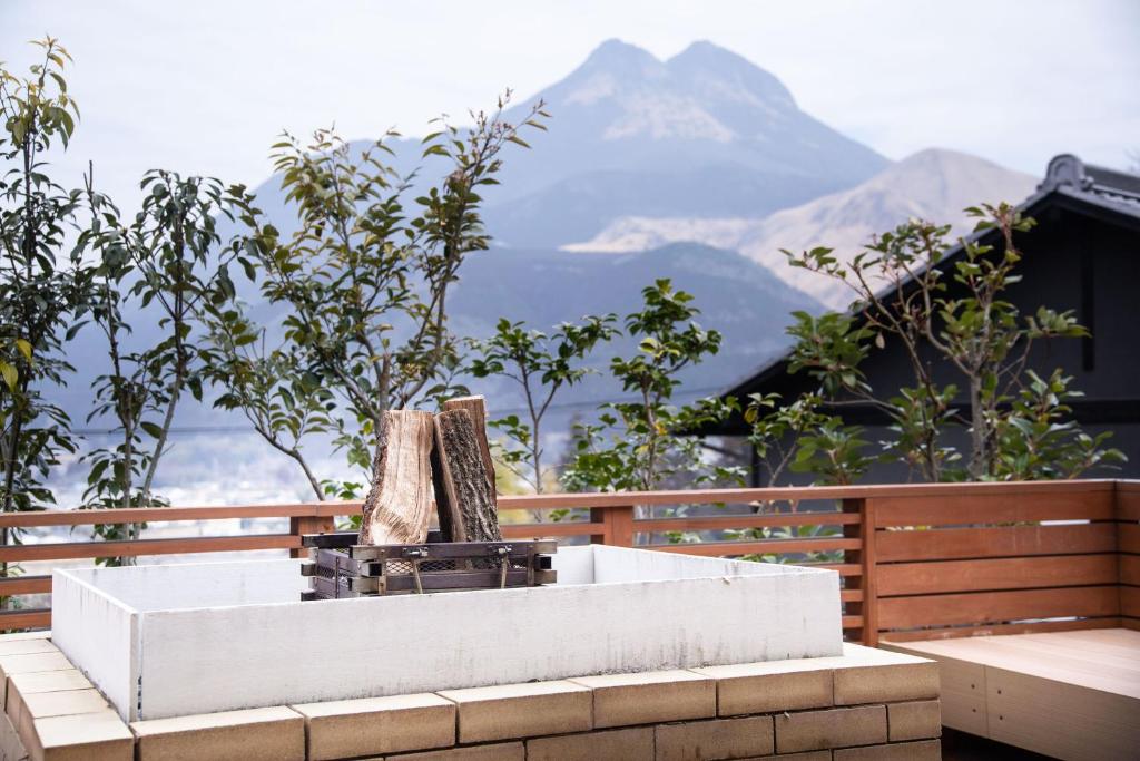 a bath tub with a view of a mountain at Yufudake Ichibo no Yado Kirara in Yufuin
