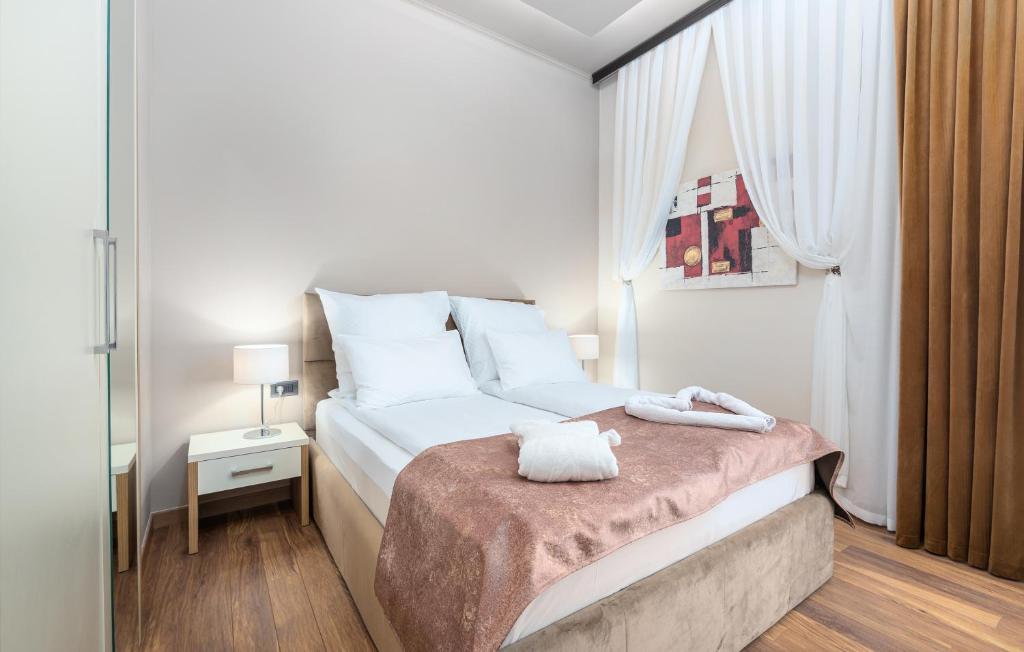 a bedroom with a bed with two towels on it at Hotel Dua Residence in Poreč