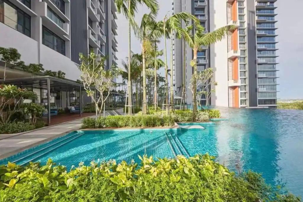an infinity pool in a building with tall buildings at Grand Medini Residence @ UHA in Nusajaya