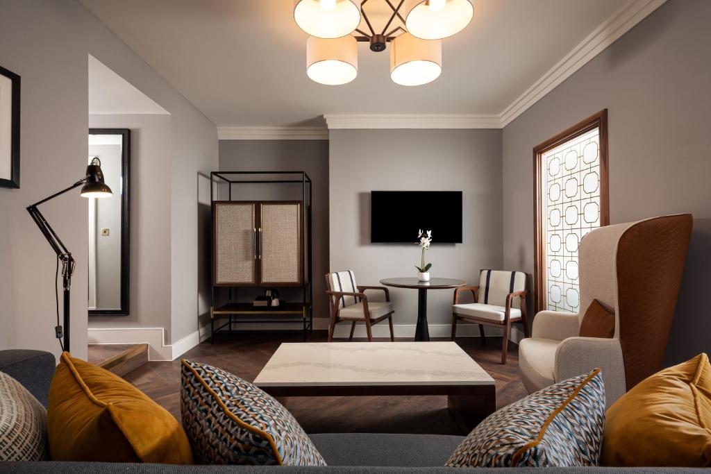 a living room with a couch and a table at The Parkgate Hotel in Cardiff