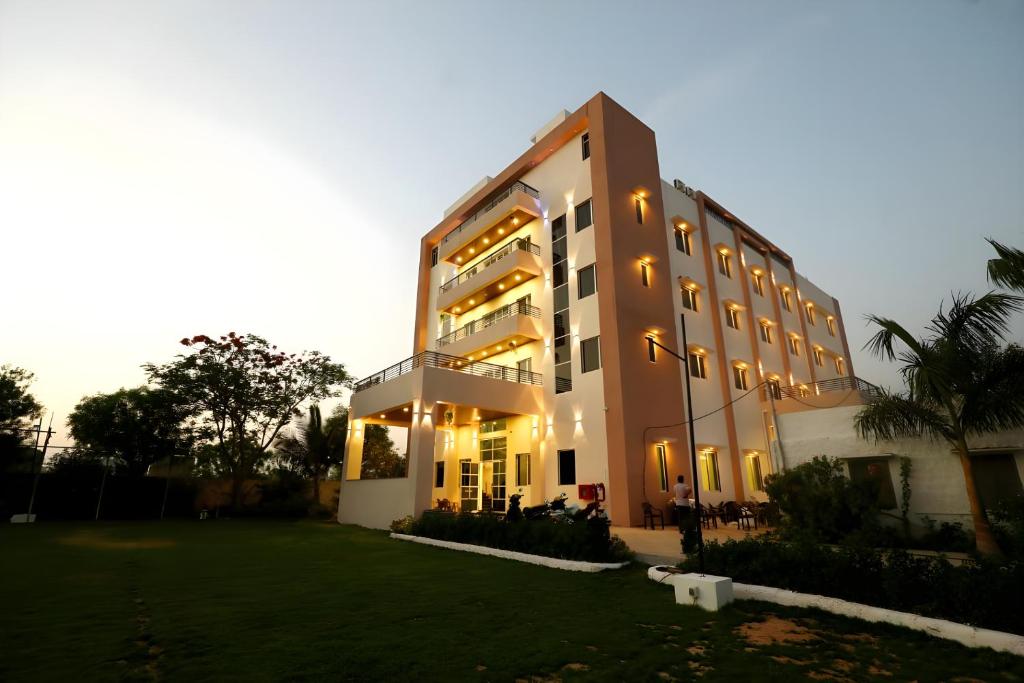 a large building with a lawn in front of it at Sun Stone Hotel & Club - Jawai in Sheoganj