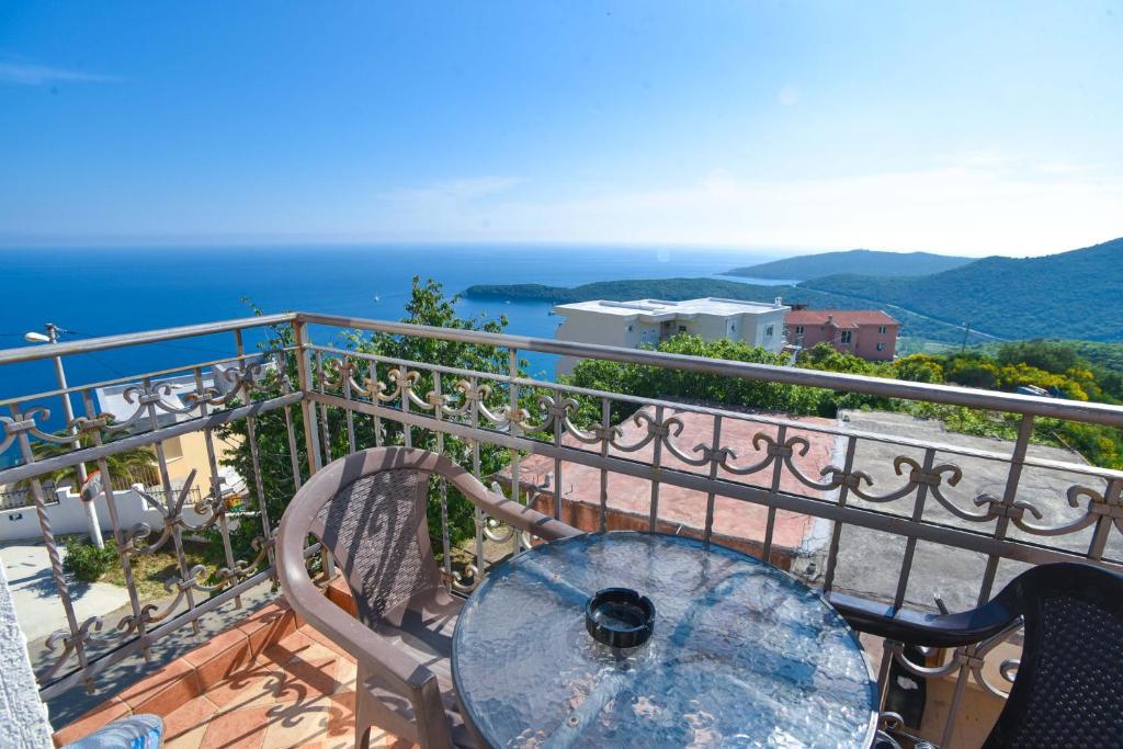 a table on a balcony with a view of the ocean at Apartments Villa Sveti Nikola in Budva