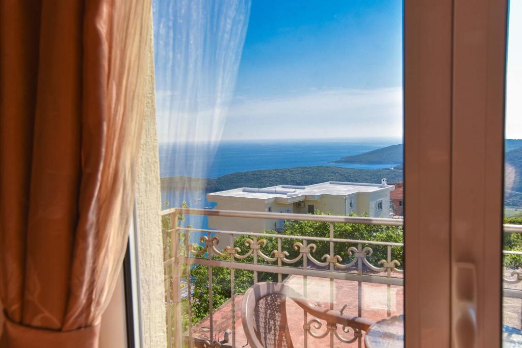 a room with a view of the ocean from a window at Apartments Villa Sveti Nikola in Budva