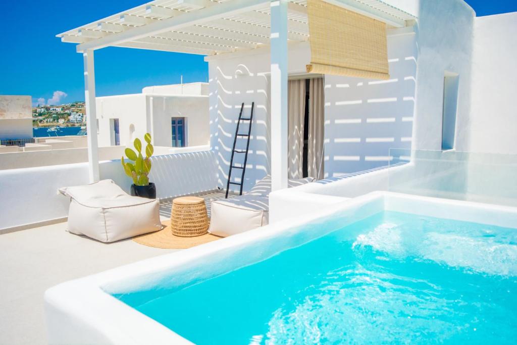 a pool in a villa with a view of the ocean at White Blossom in Parikia
