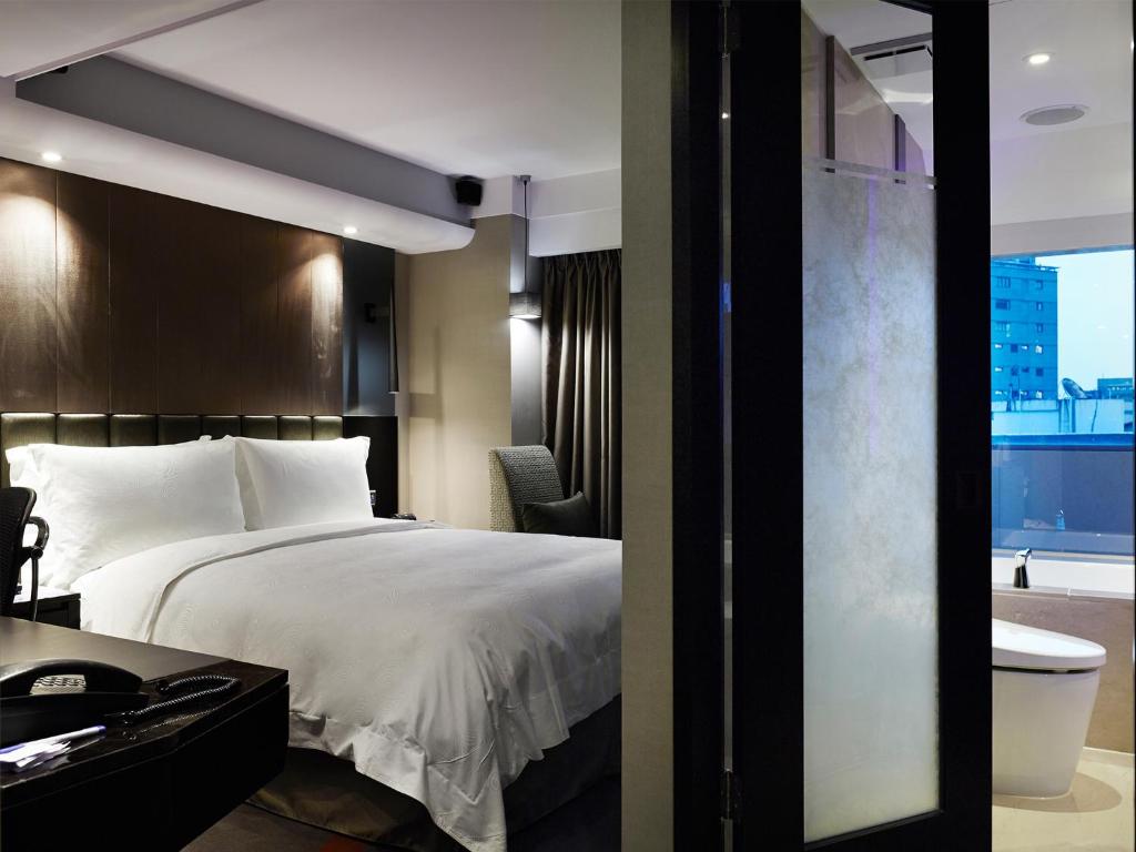 Postel nebo postele na pokoji v ubytování The Tango Hotel Taipei FuHsing