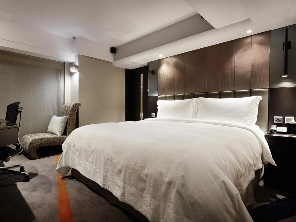 Postel nebo postele na pokoji v ubytování The Tango Hotel Taipei FuHsing