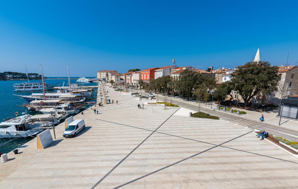 a city street with boats parked on the water at Hotel Dua Residence in Poreč