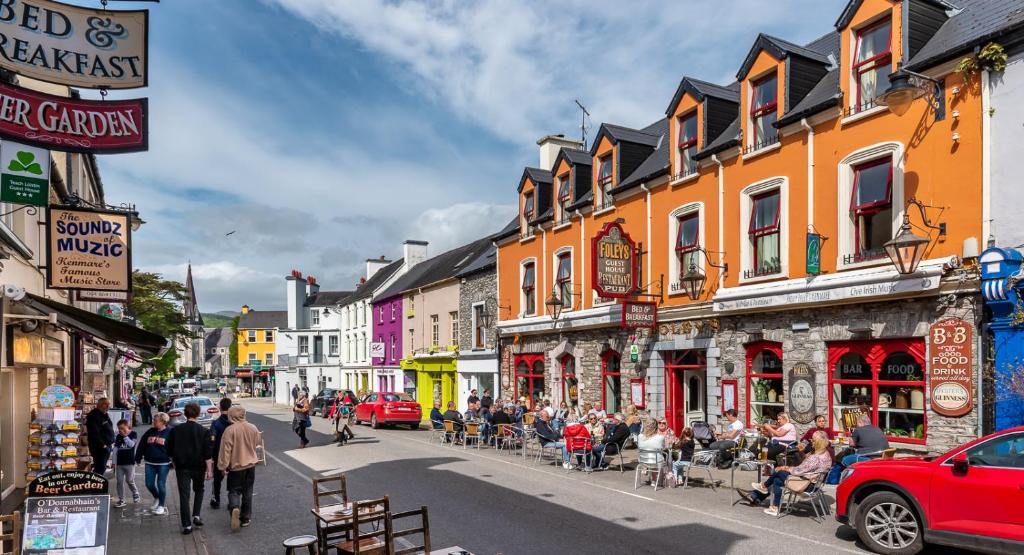 a group of people walking down a busy city street at Foley's Guesthouse & Self Catering Holiday Homes in Kenmare