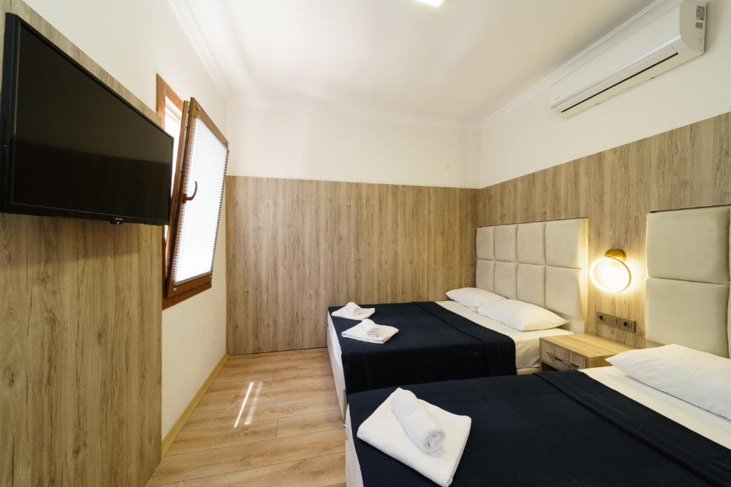 A bed or beds in a room at Hotel Centro Bodrum