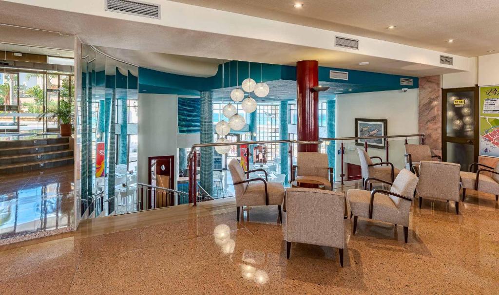 a dining room with chairs and a table in a building at Perla Marina in Nerja