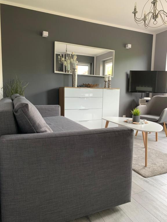 a living room with a couch and a table at Marias Apartment in Międzyzdroje