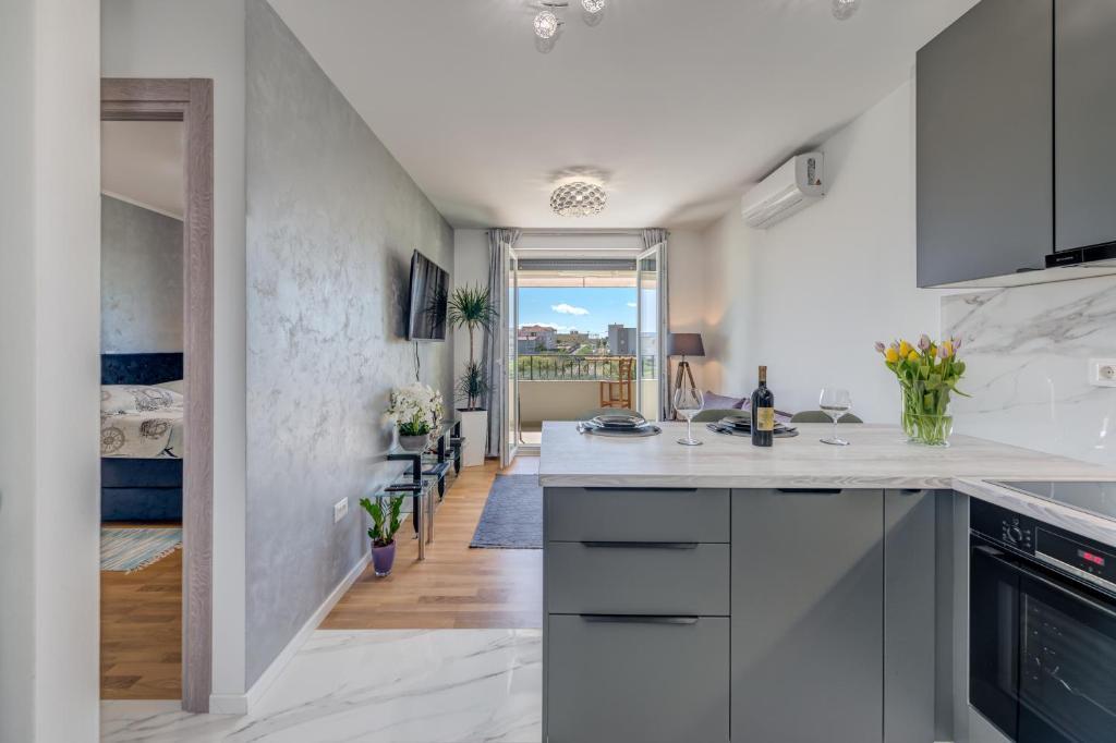 a kitchen with white countertops and a hallway at SEARENITY in Split