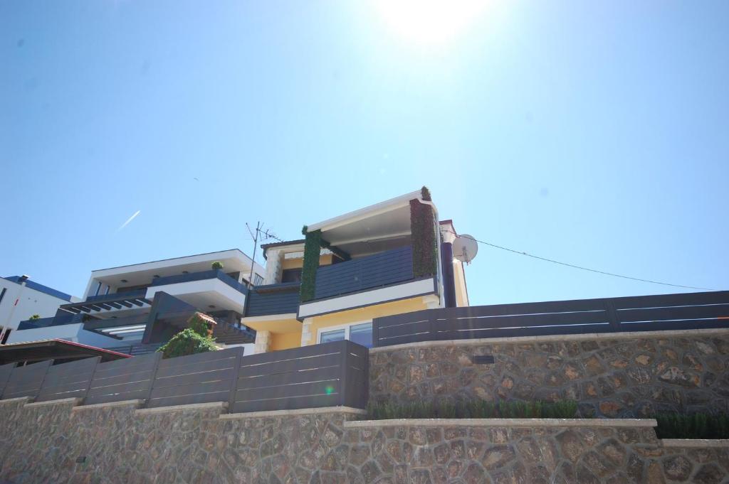 a building on top of a stone retaining wall at Apartment Poljak Njivice in Njivice