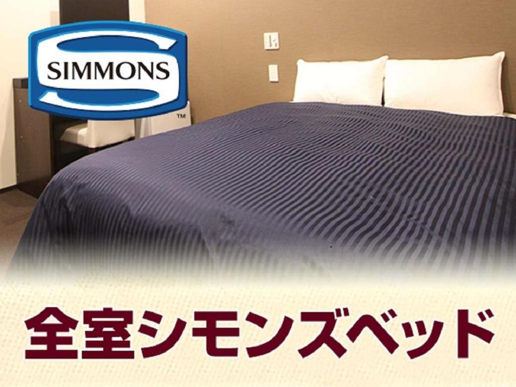 Postel nebo postele na pokoji v ubytování HOTEL LiVEMAX Akabane-Ekimae