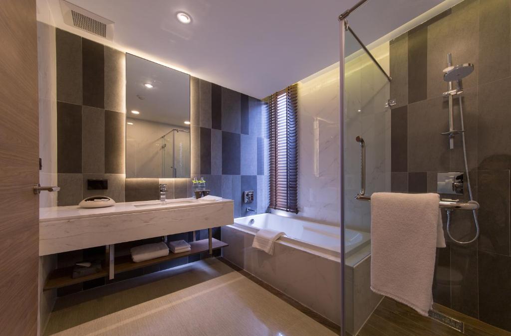 a bathroom with a tub and a sink and a shower at LiT BANGKOK Residence - SHA Extra Plus in Bangkok
