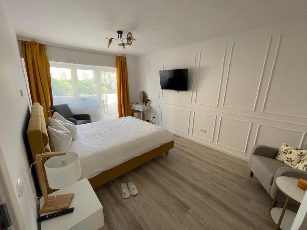 una camera da letto con un letto, una tv e un divano di Premium JD Studio a Bucarest