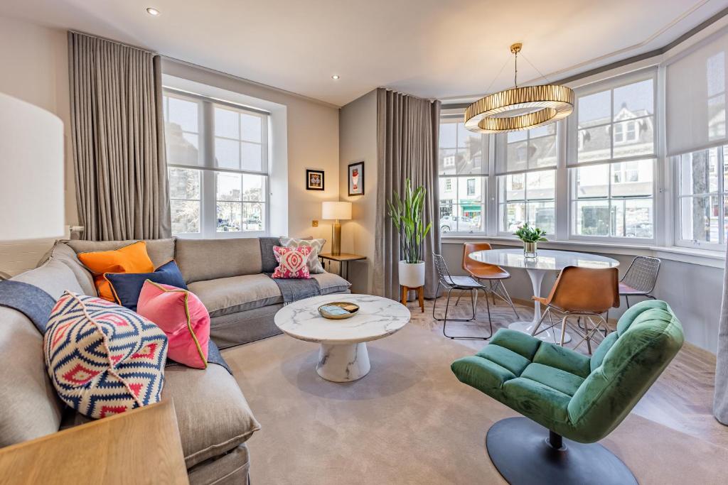 a living room with a couch and a table at No1 Apartments St Andrews - South Street in St. Andrews