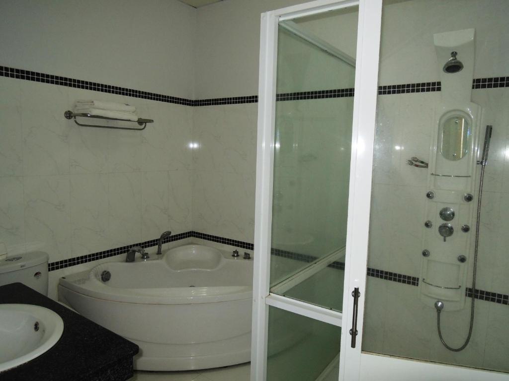a bathroom with a shower and a toilet and a sink at Hung Vuong Hotel in Tuy Hoa