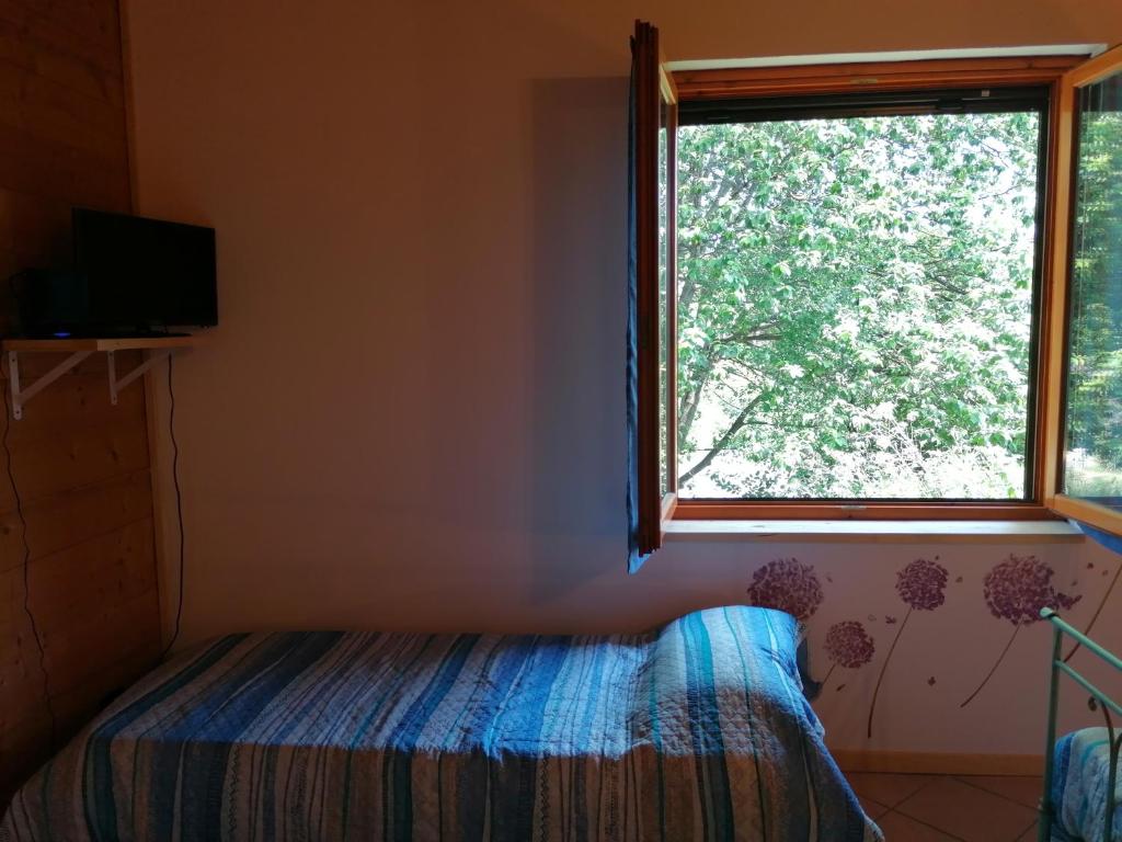 Postel nebo postele na pokoji v ubytování Agriturismo bio Apipoli