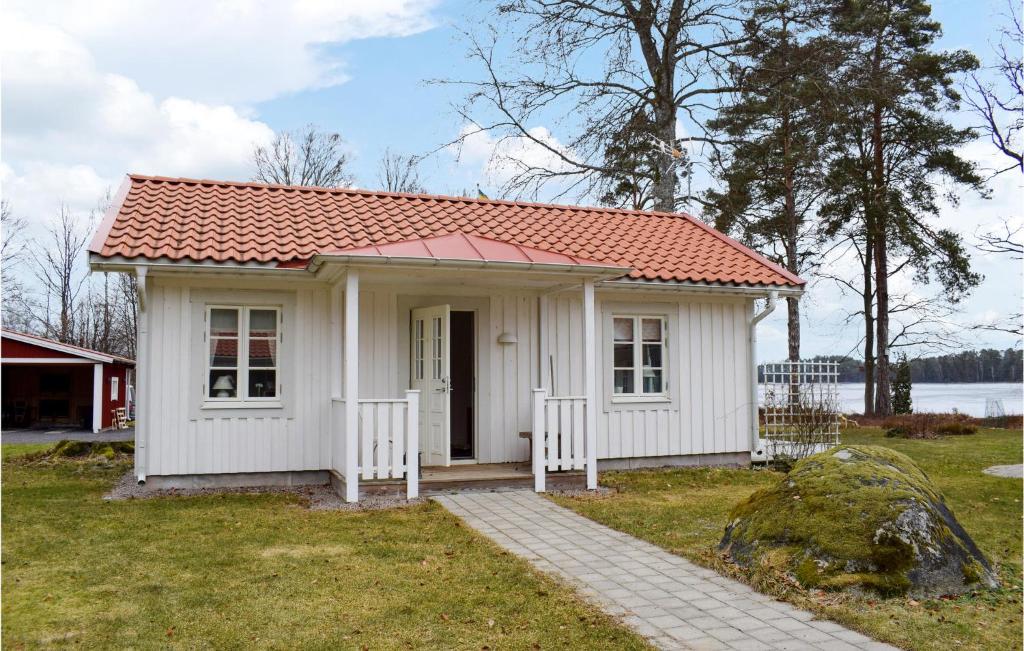 a small white house with a red roof at Nice Home In Vxj With 2 Bedrooms And Wifi in Växjö