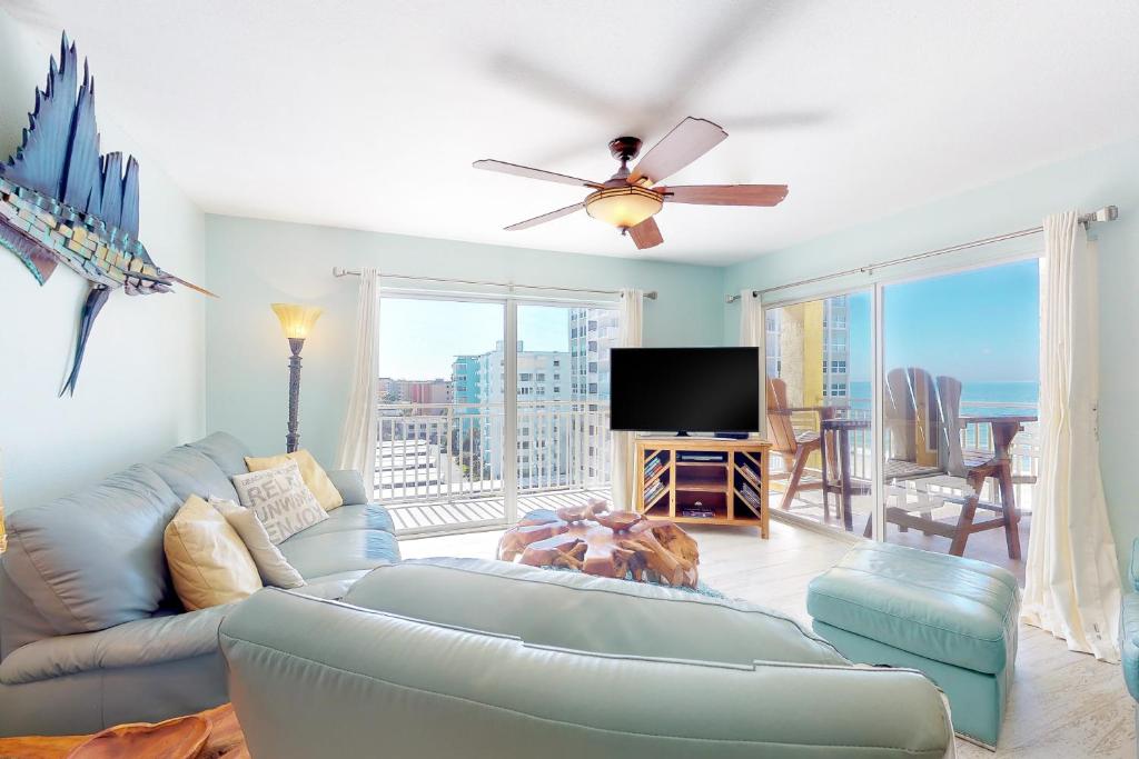 a living room with a couch and a flat screen tv at Anglers Cove 602 in St. Pete Beach