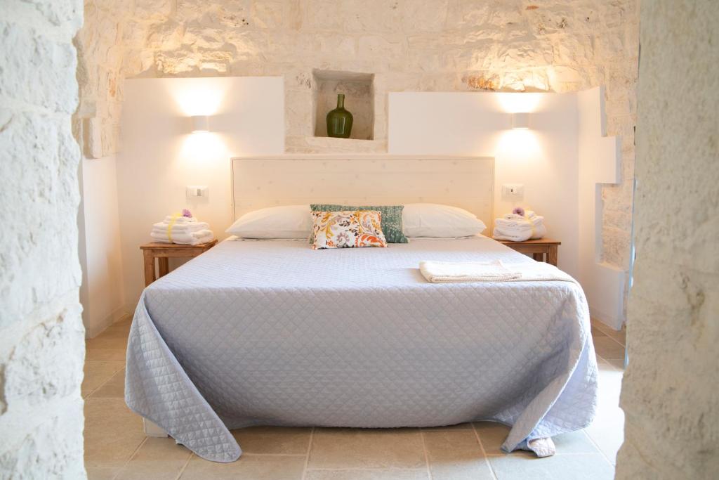 A bed or beds in a room at Dimore Angiulli - Trulli di Charme