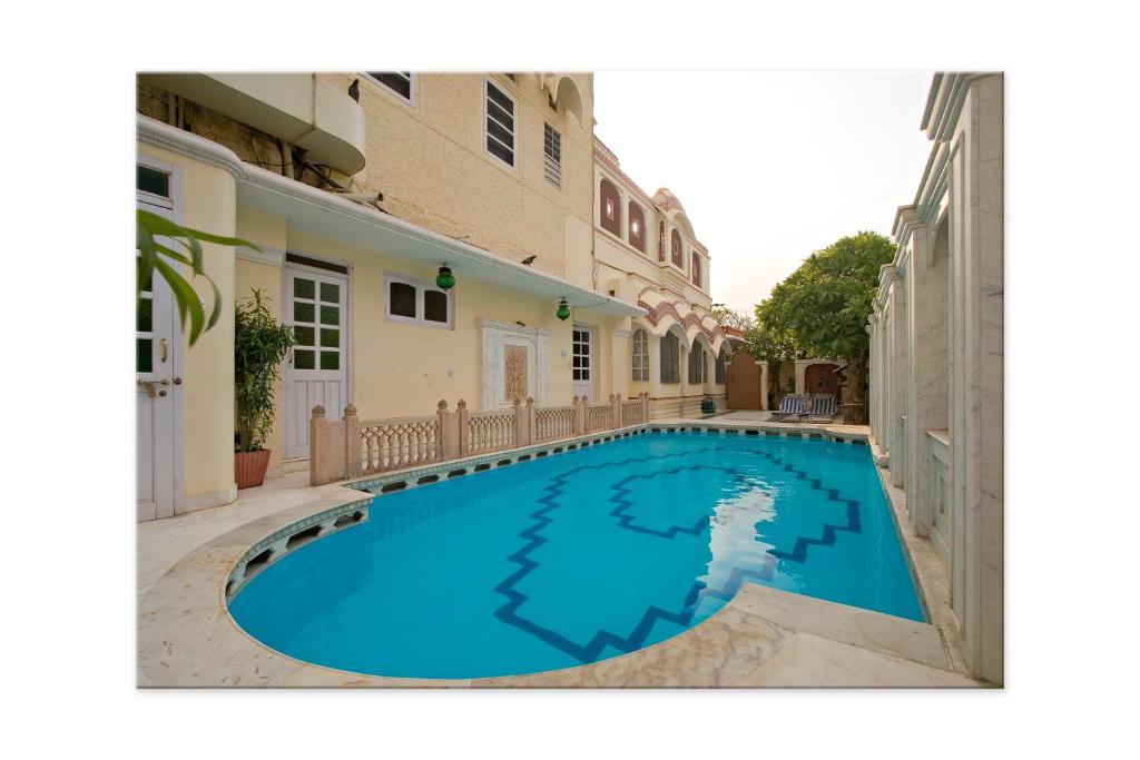 a swimming pool in the courtyard of a house at Madhuban - A Heritage Home in Jaipur