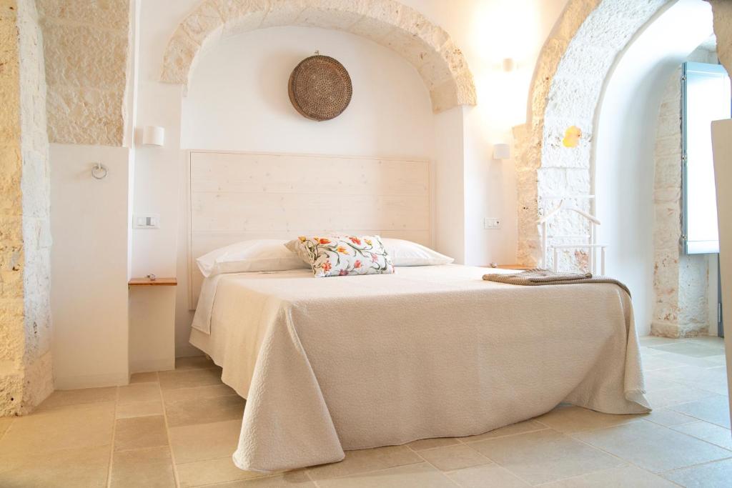 A bed or beds in a room at Dimore Angiulli - Trulli di Charme