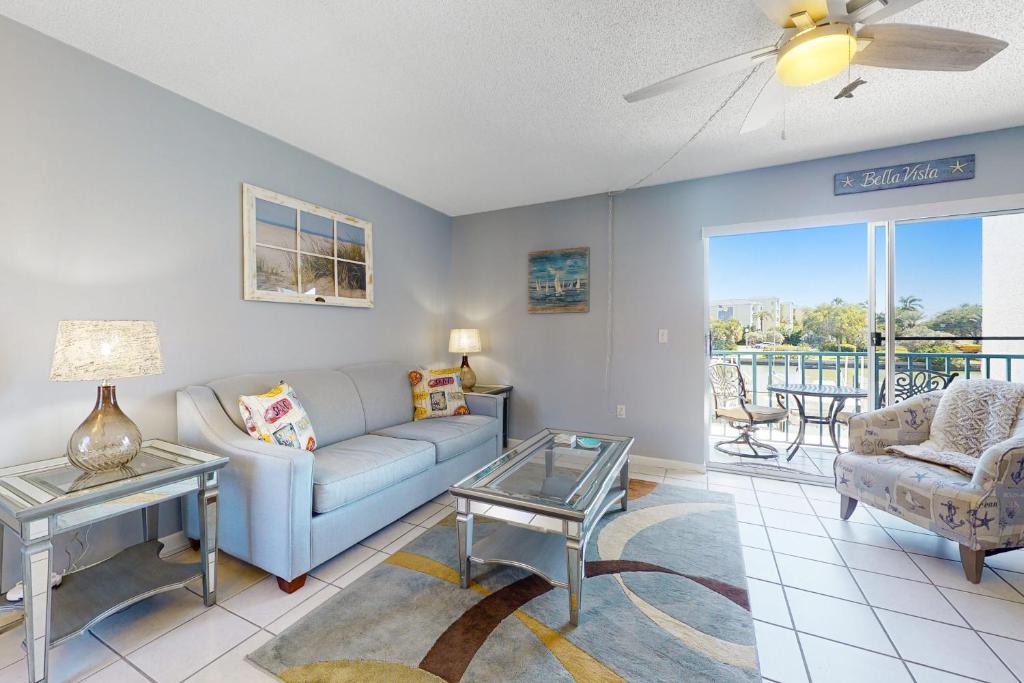 a living room with a couch and a table at Madeira Beach Yacht Club 329H in St. Pete Beach