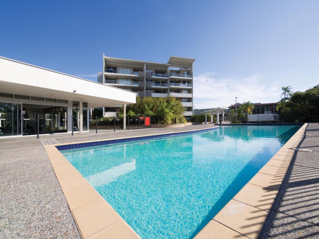 a large swimming pool in a large building at Oaks Brisbane Mews Suites in Brisbane
