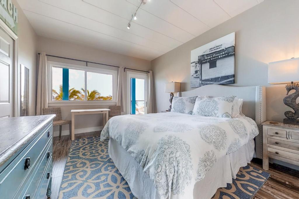 a bedroom with a white bed and a window at Bungalow Beach Place 7 in Clearwater Beach